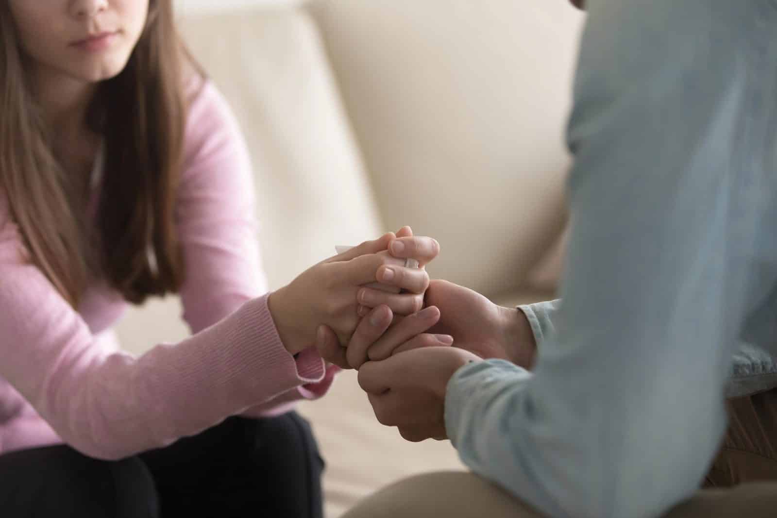 A person gently holding the hands of a grieving loved one — compassion and support after a wrongful death in Atlanta.