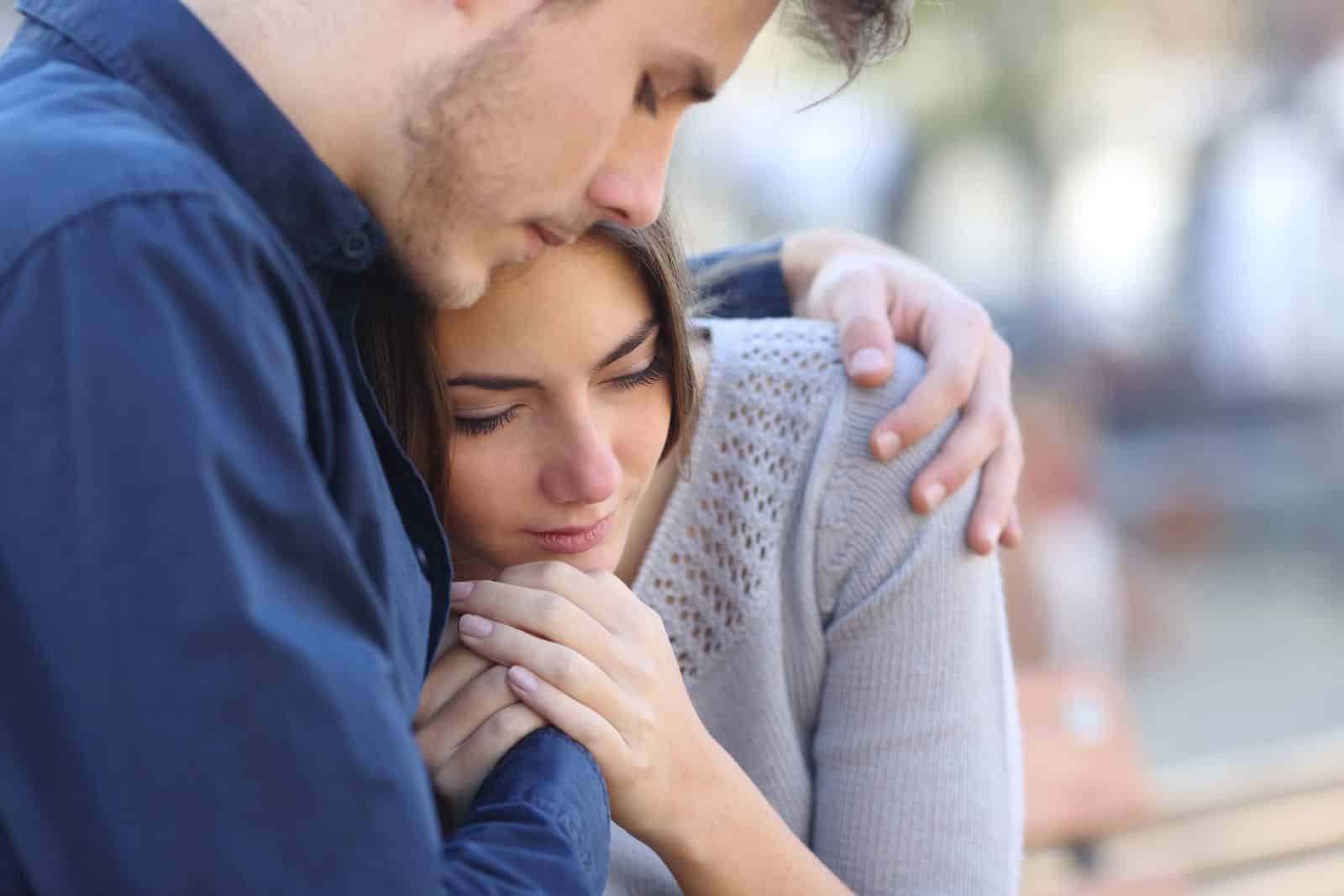 A person comforting a grieving family member after a fatal Cordova, Tennessee crash