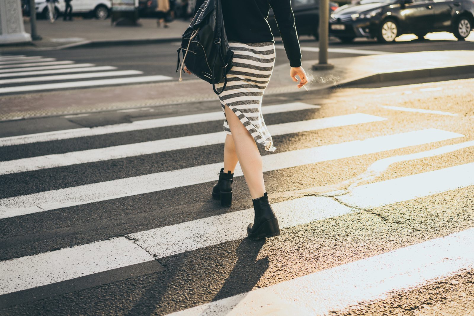 Pedestrian crossing a city crosswalk with traffic in Germantown, Tennessee
