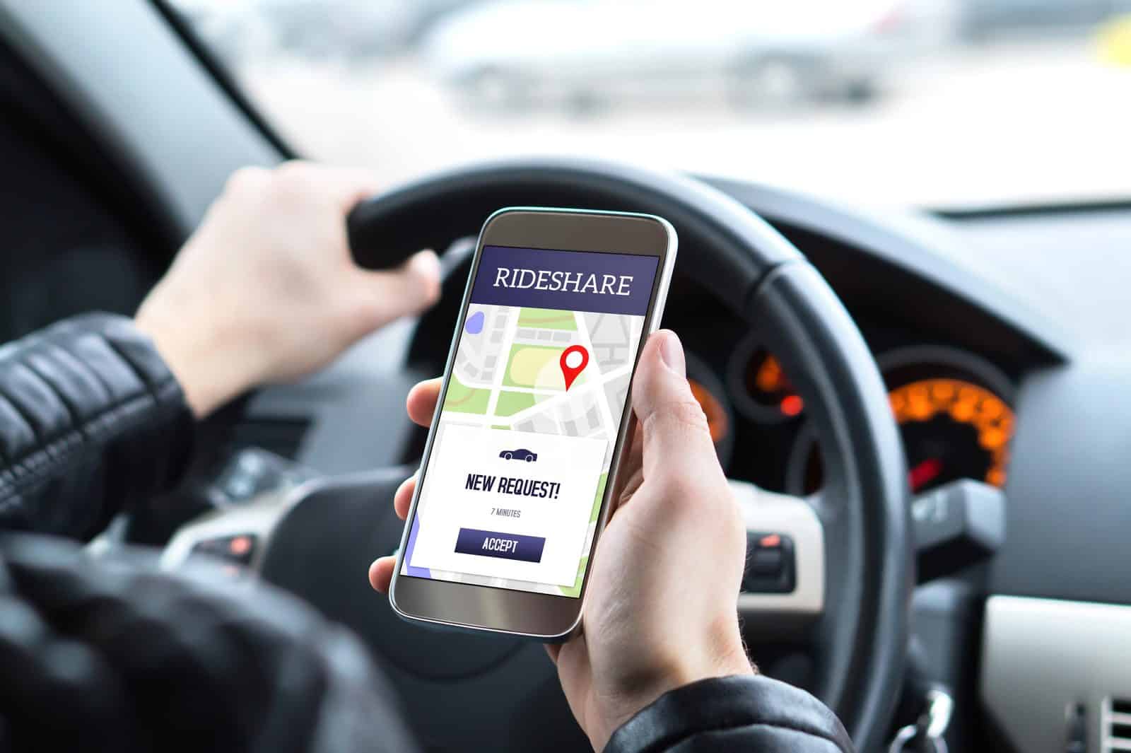 Rideshare driver using the Uber and Lyft app inside a car in Germantown, Tennessee