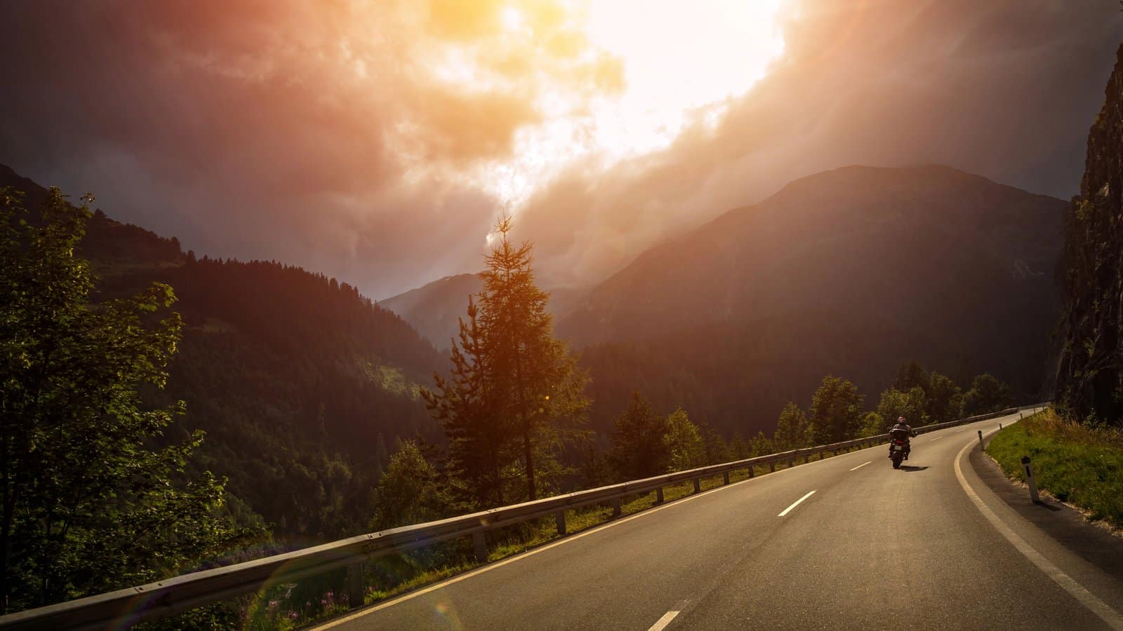 Motorcyclist riding into the sunset on a Louisville, Kentucky highway