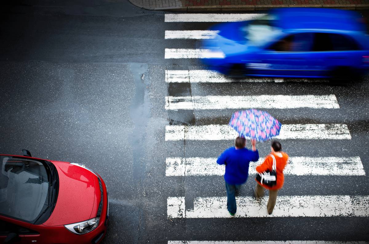 Pedestrians crossing a marked crosswalk as vehicles approach in Olive Branch, Mississippi