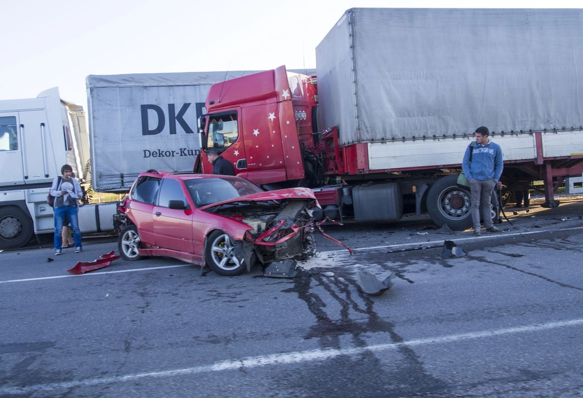 Wrecked passenger car crushed against an 18-wheeler after a truck collision near Olive Branch, Mississippi