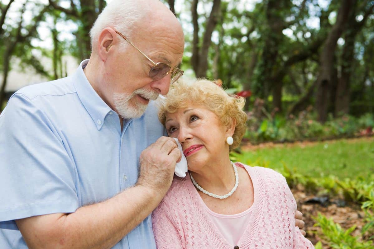 An older Southaven, Mississippi couple comforting one another while grieving the loss of a loved one in a fatal crash